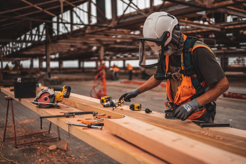 Carpenter carrying lumber during a remodel